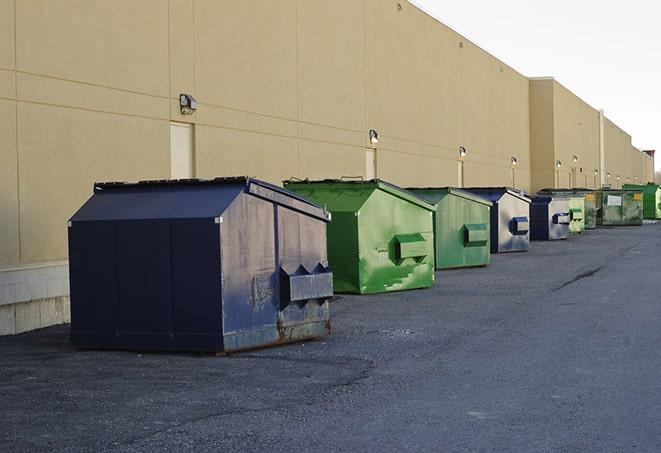 multiple construction dumpsters at a worksite holding various types of debris in Copeland